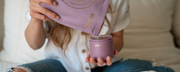 Supplement pouch being poured into glass storage container by mother with baby’s leg cozy next to her - WeNatal prenatal